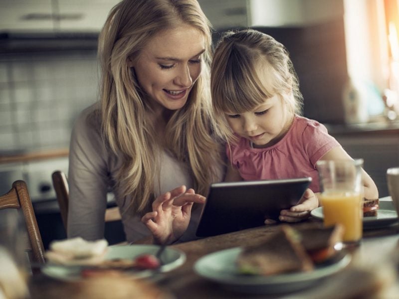 Photo of a mother and daughter having breakfast Picture of a mother and daughter having breakfast and surfing the net